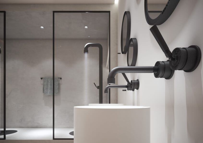Minimalistlik vannituba tööstusliku stiiliga mustade seinasegistite, ümarate peeglite ja silindrikujuliste valgete valamute ees. Taustal on klaasist seintega dušinurgad mattmustade detailidega.
