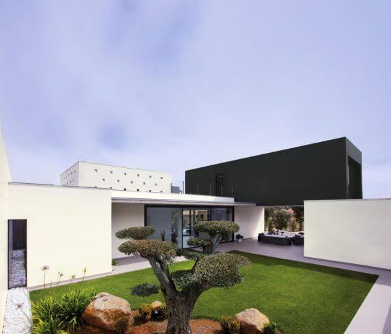 Coverlam Basic Negro – suur must plaat kaasaegse arhitektuuriga hoone fassaadil