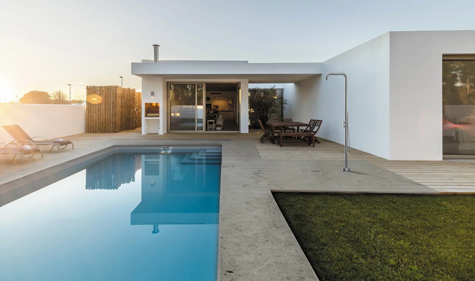 Modernne välibasseini ala, kus Deante dušikolonn lisab stiilse ja praktilise võimaluse end enne või pärast ujumist värskendada.